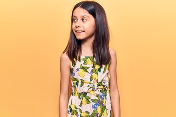 Obraz premium Beautiful child girl wearing casual clothes looking to side, relax profile pose with natural face and confident smile.