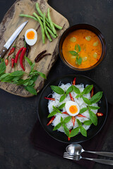 Rice noodles with curry - red creamy coconut milk curry with fish of vegetable very popular thai food called khanom jeen nam ya