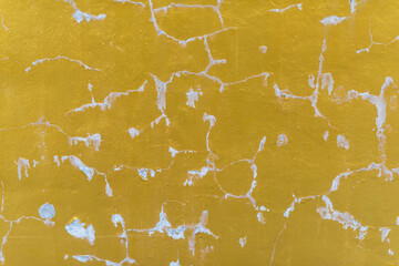 Old gold paint texture. paint peels off. Gold texture covered with cracks.