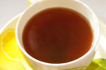 Hot herbal tea in a bright, colorful cup.