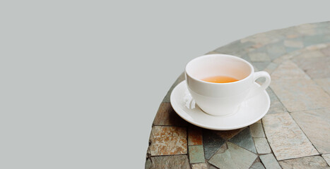 white porcelain tea Cup on a round table, isolated, selective focus