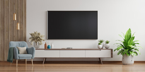 Smart TV on the white wall in living room with armchair,minimal design. - obrazy, fototapety, plakaty