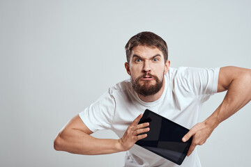 emotional man with tablet in hand touch screen new technologies light background cropped view Copy Space