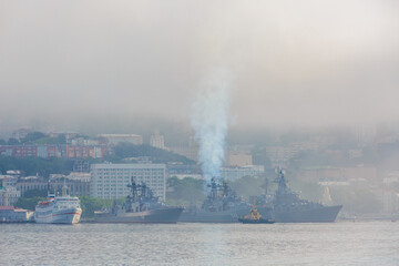 Naklejka na ściany i meble Vladivostok seaport. Various merchant ships stand on the roadstead in the Golden Horn Bay in Vladivostok during heavy fog