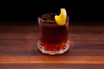 Vieux Carre cocktail with a large rock and lemon peel - obrazy, fototapety, plakaty