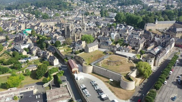 Flight over the city Guingamp and Basilica of Our Lady of Merciful on summer day. France