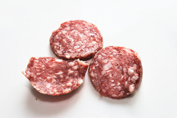 Three pieces of dry-cured sausage.