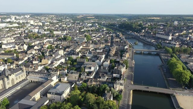 View from Mayenne river of illuminated castle and bridge of Laval town at summer night, southwestern France. High quality 4k footage