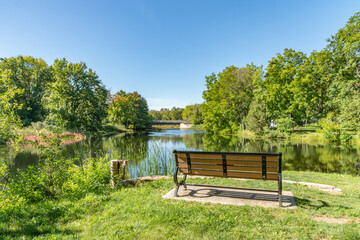 Fototapeta na wymiar Bench over a beautiful park setting landscape