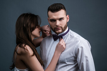 Sexy couple in love. Sensual passion lovers. Mans bowtie, bow tie.