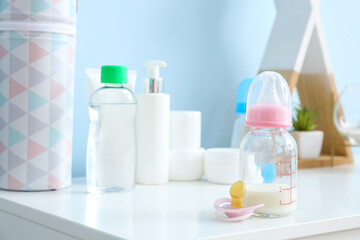 Bottle of milk for baby with pacifier on table