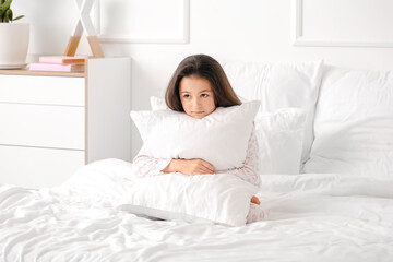 Little girl suffering from sleep disorder in bedroom