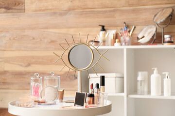 Set of decorative cosmetics and mirror on dressing table