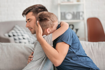 Father trying to make peace with son after quarrel at home