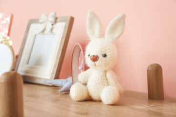 Cuddly toy on shelf in children's room