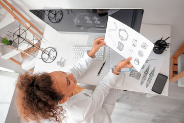 Female jewelry designer working in office