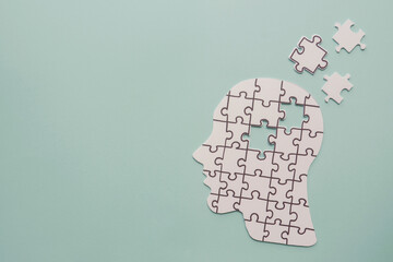 brain with puzzle paper cutout, autism, memory loss, dementia and alzheimer awareness, world mental health day concept