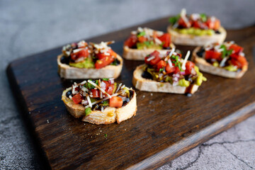 Bruschetta Sandwich served as an appetizer with tomato, avocado, onion and balsamic glaze