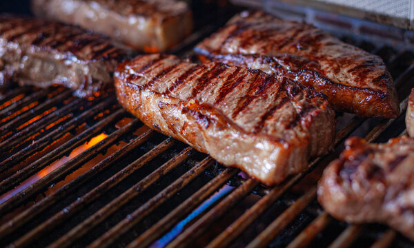 New York Strip Cut Beef - Barbeque Meat on a Grill, ready to Eat, with Copy Space