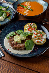 Grilled pork hamburger with baked rustic potato and rich creamy sauce, close up view, yummy photo