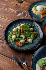 Close up, side view of spinach and mozzarella balls salad with cherry tomatoes