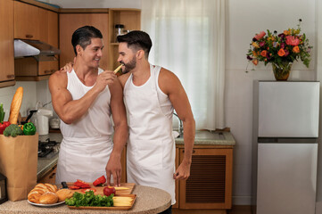 Happy LGBT couples cook in the home family kitchen together with love, smile and romantic moment