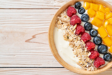 homemade yogurt bowl with raspberry, blueberry, mango and granola