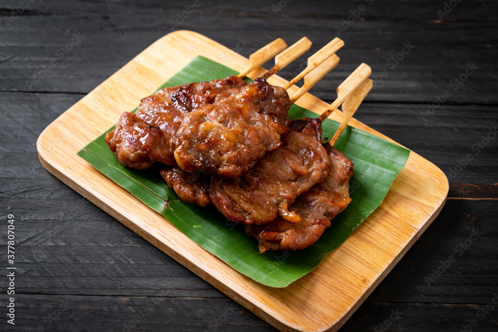 Poster grilled skewered milk pork with white sticky rice