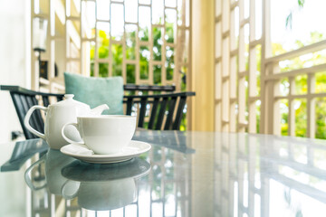 tea cup with teapot on table