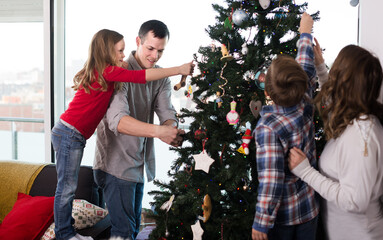 Cheerful family members preparing for Christmas together at home