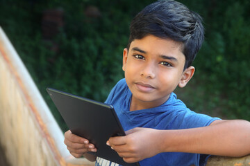 Indian little boy attending the online class at home