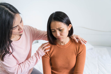friendship and people consoling friend concept.Good friends embracing in a bedroom.Two women talking about problems at home unhappy girl support and care her girlfriend.