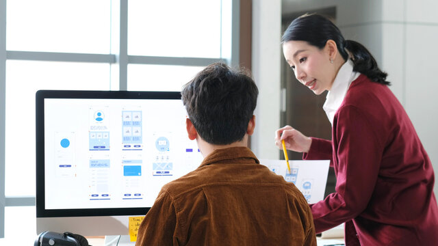 Website designer, Creative planning phone app development template layout framework wireframe design, User experience concept, Young asian woman and man UX designer working on smartphone application