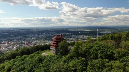 Pagoda building in Reading Pennsylvania USA, on hilltop overlooking urban city downtown on beautiful summer day, Americana establishing shot, Chinese Japanese Asian architecture