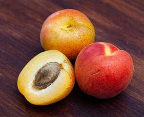 Naklejka na ściany i meble Group of fresh sweet apricot fruits on wooden table