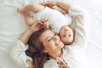 Small child with a woman. Baby with mom. High quality photo.