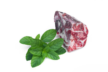 Obraz premium Frozen beef isolated on white background decorated with greens.