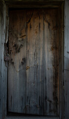 an old rotten wooden door with a broken lock