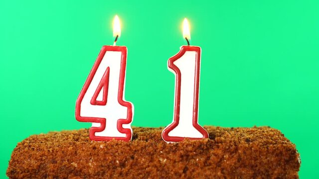 Cake with the number 41 lighted candle. Chroma key. Green Screen. Isolated