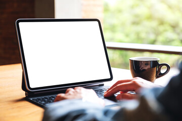 Mockup image of a woman using and typing on digital tablet keyboard with blank white desktop screen...