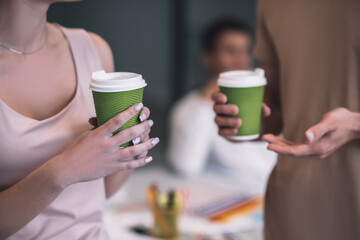 Close up picture of hands holding cups