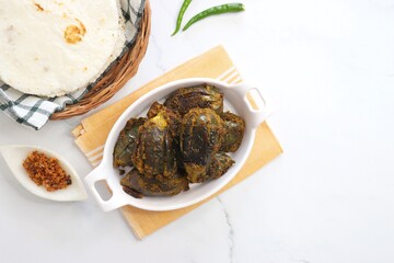 Indian, Maharashtrian side dish or appetizer Bharli Vangi, stuffed Eggplants, Crispy brinjal fry, Aubergine stuffed, served with Rice flour bhakri. copy space