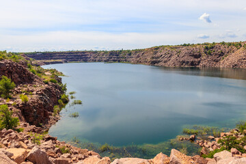 Obraz premium View of the lake at abandoned quarry on summer