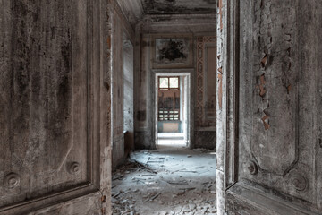 Abandoned mansion interior. Half open grunge doors. Old palace enfilade. Spooky haunted house concept.