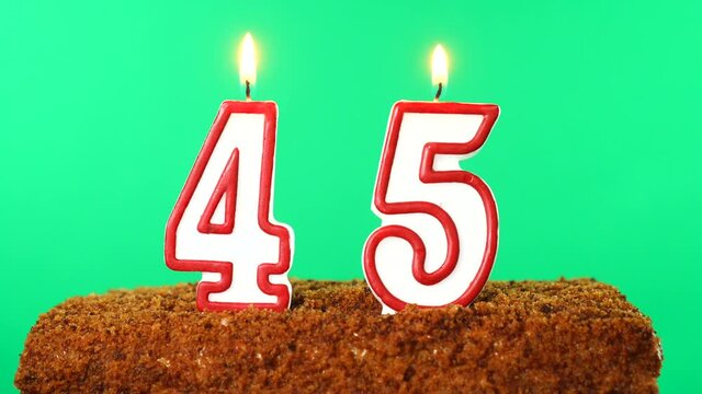Cake with the number 45 lighted candle. Chroma key. Green Screen. Isolated