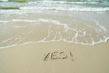 Fototapeta premium YES concept, word written on sand beach