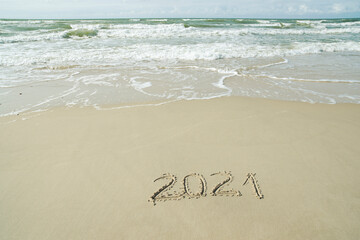 2021 inscription written on the sand, New Year is coming concept