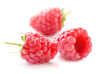 Ripe red raspberries on white