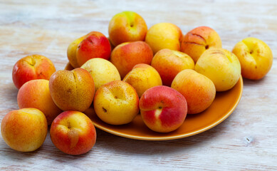 Fototapeta na wymiar Group of fresh sweet apricot fruits on wooden table