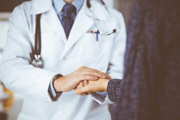 Friendly red-beard doctor reassuring his female patient, close-up. Medical ethics and trust concept, medicine theme